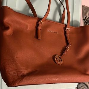 Brown Michael Kors shoulder purse with matching wallet.
